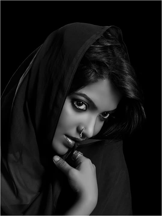 Hooded woman in black shawl