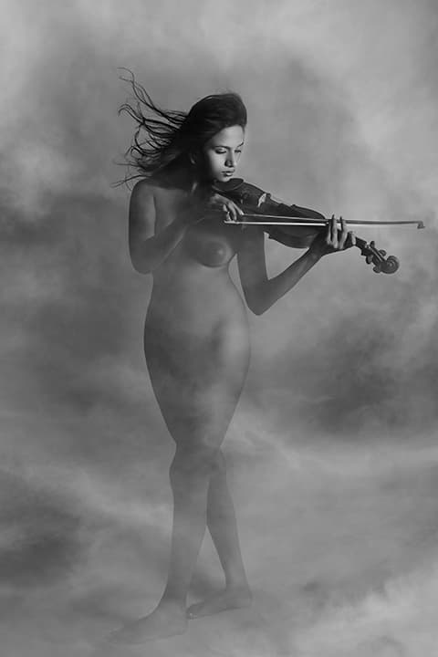Nude violinist in smoke