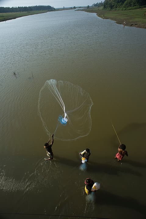 Fishermen casting a net